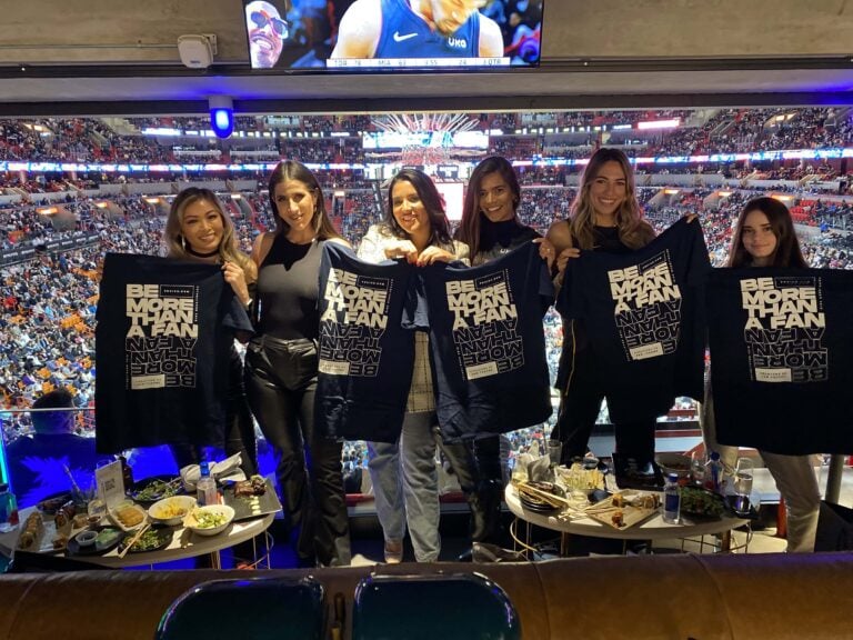 fans-holding-t-shirts-stadium-background